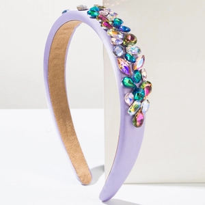 Close-up of lavender sponge headband with multicolored crystals and rhinestone embellishment