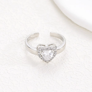 Detailed top view of an adjustable heart ring with a large zircon center and halo setting