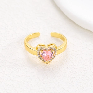 Detail of adjustable gold ring featuring a pink heart zircon and sparkling crystal halo