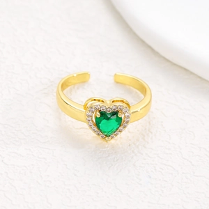 Macro view of adjustable gold ring featuring a green heart zircon with diamond halo