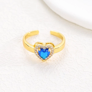 Macro view of adjustable gold ring with heart-shaped blue zircon and pavé setting