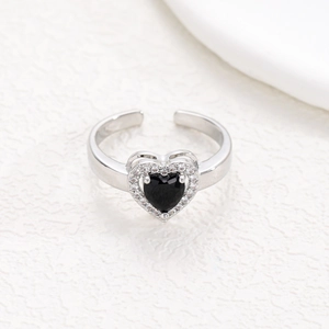 Macro detail of silver adjustable ring with heart-shaped black zircon and pavé setting