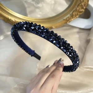 Detail of handcrafted black crystal beaded headband with shimmering multifaceted glass beads