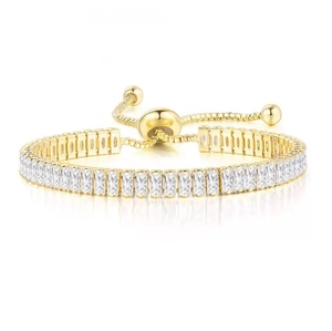 Macro detail of adjustable gold tennis bracelet featuring rectangular cubic zirconia stones