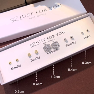 Detailed set of S925 silver stud earrings in a white gift box with snowflake and ball designs