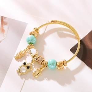 Gold owl and turtle charm bracelet with mint green beads and twisted wire band