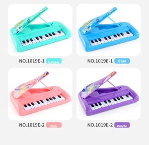 Detail view of 13-key toy pianos in mint green, sky blue, light pink and purple colors