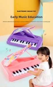 Close-up of portable electronic piano toy for kids with 13 keys in pink and purple colors