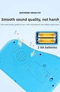 Rear view of blue kids electronic organ showing battery compartment for 2x AA batteries