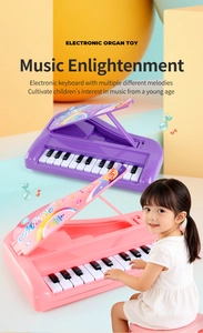Close-up of a young girl playing the pink 13-key portable electronic keyboard toy