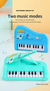 Detail view of 13-key portable electronic piano toy showing music mode switch and open lid