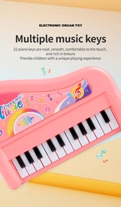 Close-up of pink 22-key electronic piano toy with colorful music stickers for kids