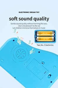 Detail view of the back of blue kids electronic piano showing battery compartment and speaker