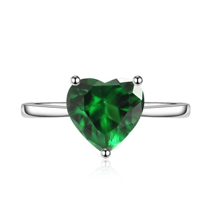 Macro shot of silver ring featuring a large heart-shaped green zircon in a 3-prong setting