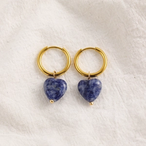 Detailed macro shot of 18K gold hoop earrings with heart-shaped blue natural stone charms