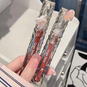 Detail showing crystal-cut lip glaze tubes with cute bear and fish decorations