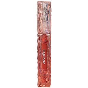 Moisturizing mirror lip glaze in diamond textured pink casing with orange-red tint