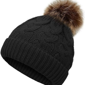 Winter cable knit beanie for children featuring a classic black pom-pom design