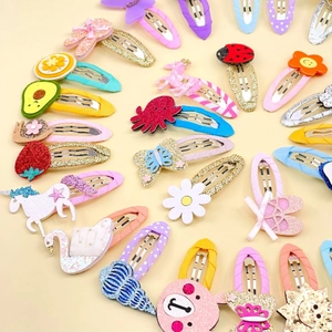 Colorful kids hair clips set with cartoon animals and fruits sequins on yellow background