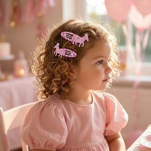Close-up of a child wearing pink sequin unicorn hair clips in a festive party setting