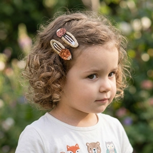 Cute sequined hedgehog hair clips worn by a girl outdoors with soft natural lighting