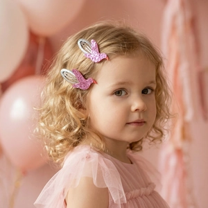 Sparkly pink bird hair clips on a girl, cute sequined glitter BB hair pins for kids