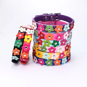 Detail view of colorful PU leather dog collars featuring 3D floral rivet decorations
