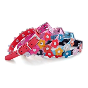 Set of colorful PU leather dog collars with flower charms in red, pink, blue, and black
