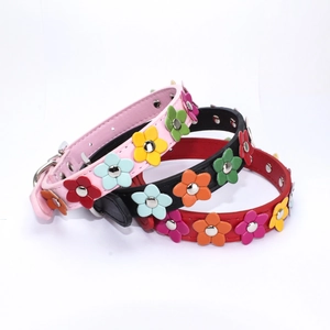 Close-up of three colorful floral PU leather dog collars with metal buckle hardware
