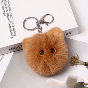 Detail view of ginger plush cat head keychain with soft faux fur and silver metal clasp