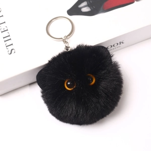 Detailed view of 8cm black fluffy plush cat head keychain with realistic orange eyes
