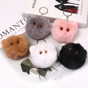 Five assorted fluffy plush cat head keychains in grey pink brown white and black colors
