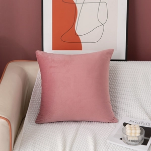 Detail of luxury dusty rose velvet square pillowcase on a leather sofa in a modern living room