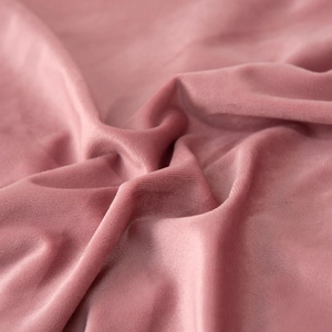 Close-up of premium pink velvet fabric with soft texture for luxury sofa cushion covers