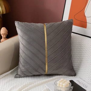 Detail of luxury dark gray velvet cushion cover with pleated texture and gold center ribbon