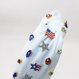 Detail of white knotted headband with rhinestone stars and American flag enamel charms