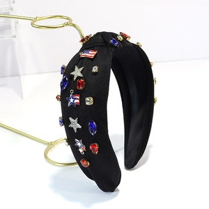 Detail of wide black knotted headband with colorful rhinestones and US flag star charms