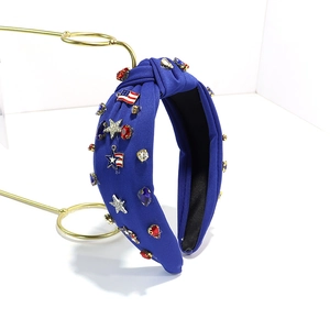 Detail of blue knotted headband with USA flag charms and colorful rhinestones