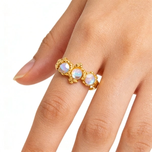 Retro stainless steel ring with three round moonstones and ornate floral carvings
