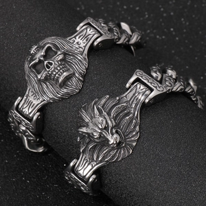Vintage gothic men's steel bracelet featuring skull and wolf motifs on a chunky link chain