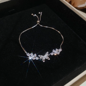 Elegant silver-tone zircon butterfly and flower bracelet with adjustable bolo clasp