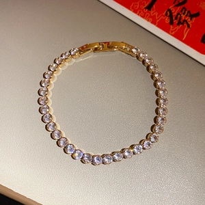 Elegant gold-plated tennis bracelet featuring sparkling clear cubic zirconia stones close-up