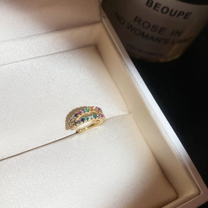 Detail shot of a gold double-row multi-color zircon ear cuff in a velvet jewelry box.