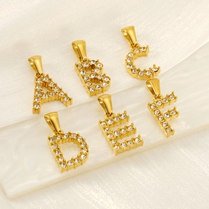 Close-up of gold-plated alphabet pendants A-F with micro-pave cubic zirconia crystals