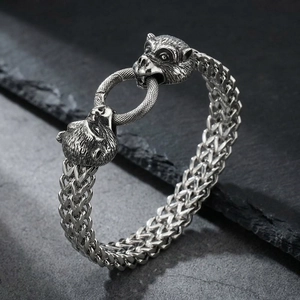 Close-up of vintage steel double beast head clasp on a braided mens viking bracelet