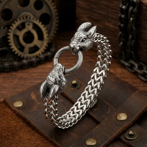 Detail of vintage braided steel bracelet with sculpted rabbit and eagle metal heads