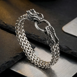Close-up of vintage braided titanium steel bracelet with double dragon heads and metal clasp