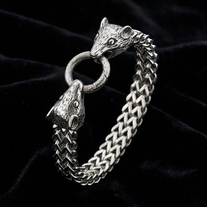 Detail of vintage braided steel bracelet with double animal heads and ring clasp