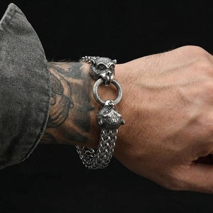 Close-up of men's double-layered woven titanium steel bracelet with vintage wolf head motifs