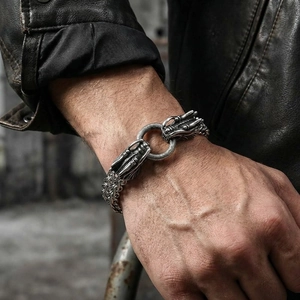 Detail of vintage dragon head bracelet in titanium steel with woven double layer chain